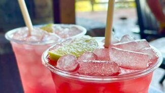 A couple of cocktails on a table by the water at Geyser Point.