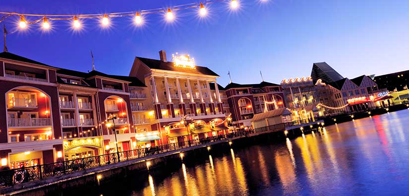 View of Disney's Boardwalk at night with lights reflecting in the water
