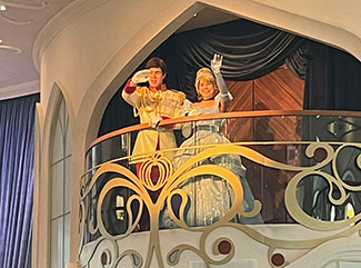 AEP-Cinderella-Wave Cinderella and Prince Charming waving from the balcony in the Atrium aboard the Disney Wish